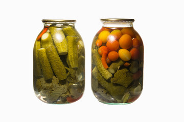 Tomatoes cucumbers, canned jars. Pickled cucumbers and tomatoes are a good snack.