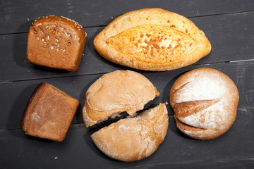 Homemade bread on a black wooden background