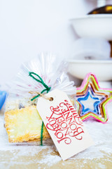 Making cookies as christmas gift, sugar powder and cookies cutter and cooking tools photographed from above on a dark and wooden background