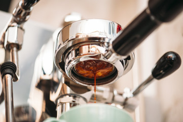 Fresh morning espresso coffee pouring through the bottomless portafilter