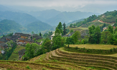 Fototapeta na wymiar Yaoshan Mountain, near the city of Guilin, Province of Guangxi. China hillside rice terrace landscape with the village
