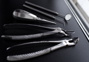 Set of metal medical equipment tools for teeth dental care isolated on black