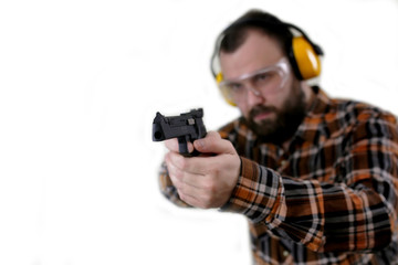 man with put on protective goggles and ear training in pistol sh