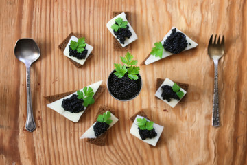 Fototapeta na wymiar snack black caviar on a wooden background