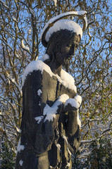 Statue of the saint covered with snow