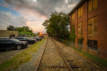 Fototapeta na wymiar Railroad tracks and buildings, in NoDa, Charlotte, North Carolin