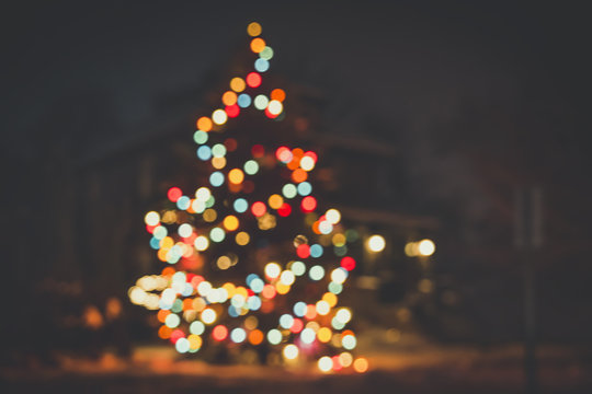 Seasonal Christmas House Lights Decoration. Outdoor blurred defocused view