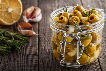 Fresh olives with rosemary, garlic, lemon.