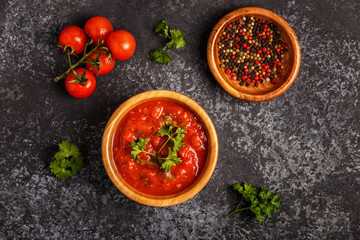 Tomato sauce with garlic and parsley in a wooden bowl.