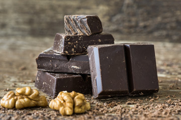 Dark Chocolate Pieces Stack on Rustic Background