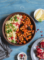 Moroccan aubergine and chickpea stew and bulgur. Healthy vegetarian lunch. On a wooden table, top view. Flat lay