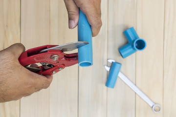 abstract plumber cutting the blue tube with red tools - can use to display or montage on product