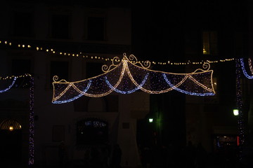 Light colored Christmas decorations at night the streets of Wars