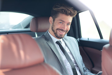 Portrait of a successful business man in his car