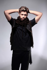 Obraz premium Portrait of young handsome fashionable man against wooden wall.