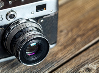 Vintage camera on wooden background