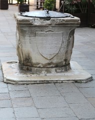 well in the plaza of an ancient European city