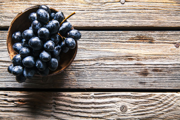 Top view of grapes in basket on wooden table. fruits