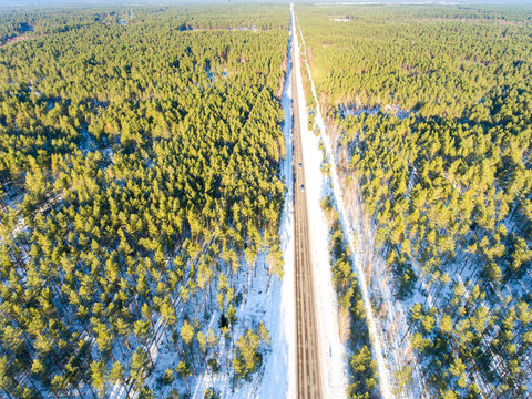 Aerial photo of infinity road surrounded by forest in winter