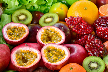 Closeup passion fruits with group of fresh fruits and vegetables for eating healthy