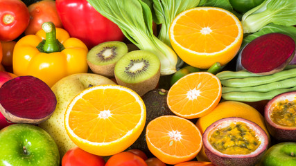 Closeup orange slice with group of fresh fruits and vegetables for eating healthy