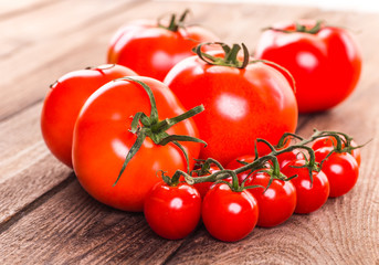 Close-up of fresh, ripe tomatoes on wood background