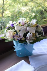 bouquet of flowers in a bucket with bows