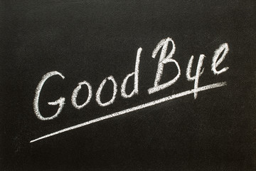 Obraz premium Goodbye word written on chalkboard