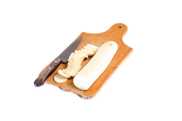 vegetable daikon sliced on a wooden cutting board close up