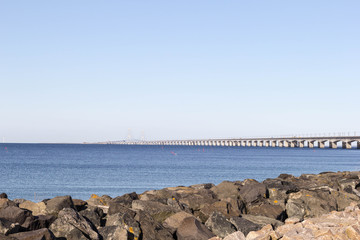 Fototapeta na wymiar The sea shore overlooking the long white bridge