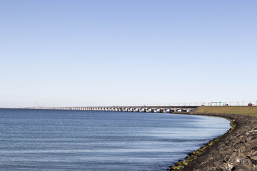 Fototapeta premium The sea shore overlooking the long white bridge