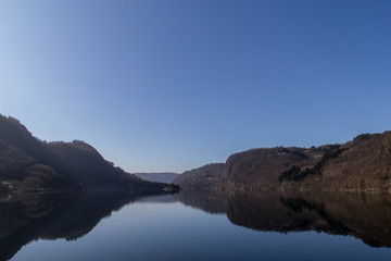 Landscape Scandinavian nature, the rocky shore of the lake, blue sky