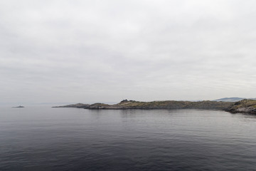 Landscape Scandinavian nature, the rocky shore of the lake, cloudy sky