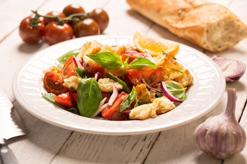 Italian Appetizer salad with tomatoes, bread and bazil