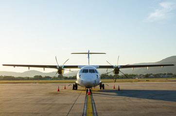 Small Airplane or Aeroplane Parked at Airport.Small Airplane Famous to use Private Airplane.Sunset Light and Mountain View.