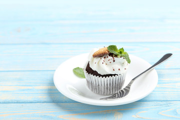 Chocolate cupcake on a blue wooden table