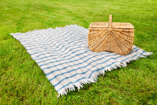 Picnic Blanket And Basket In The Grass