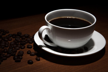 cup of coffee and beans on the table