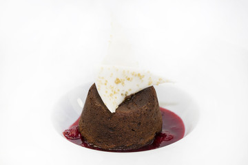 A piece of cream cake decorated with chocolate and mint