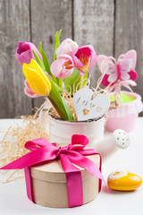 pink yellow tulips on rustic wooden background