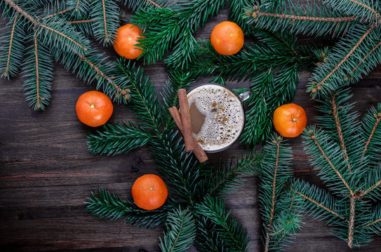Christmas background with cinnamon sticks, coffee and tangerine. Top view