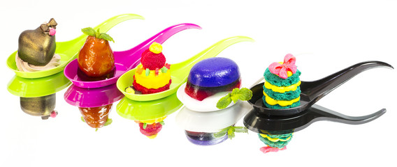 Mini desserts and meat canapes vegetable snacks in plastic cups canaps