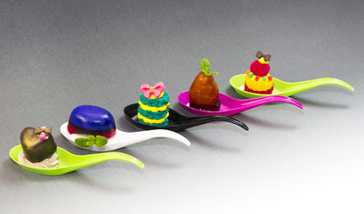 Mini desserts and meat canapes vegetable snacks in plastic cups canaps