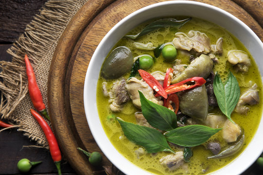 Thai food chicken green curry on dark wooden background. top view