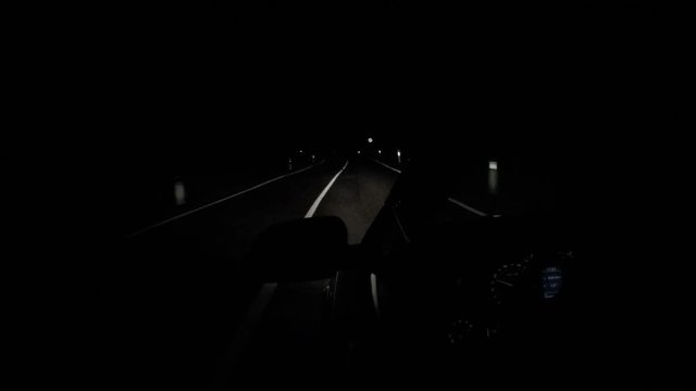 Black car driving at night - time lapse