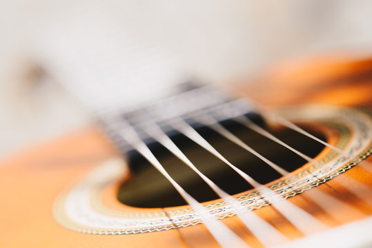 Acoustic guitar bridge and strings close up - macro - very shallow depth of field