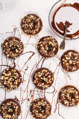 Fresh baked gluten free chocolate donuts and bowl with glaze