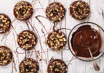 Fresh baked gluten free chocolate donuts and bowl with glaze