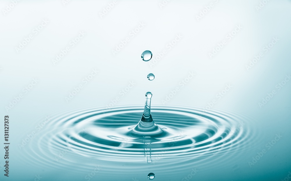 Canvas Prints water drop falling and drips on water mirror. drops splash and make perfect circles on water surface