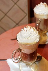 Glass cup of coffee with ice cream and whipped cream